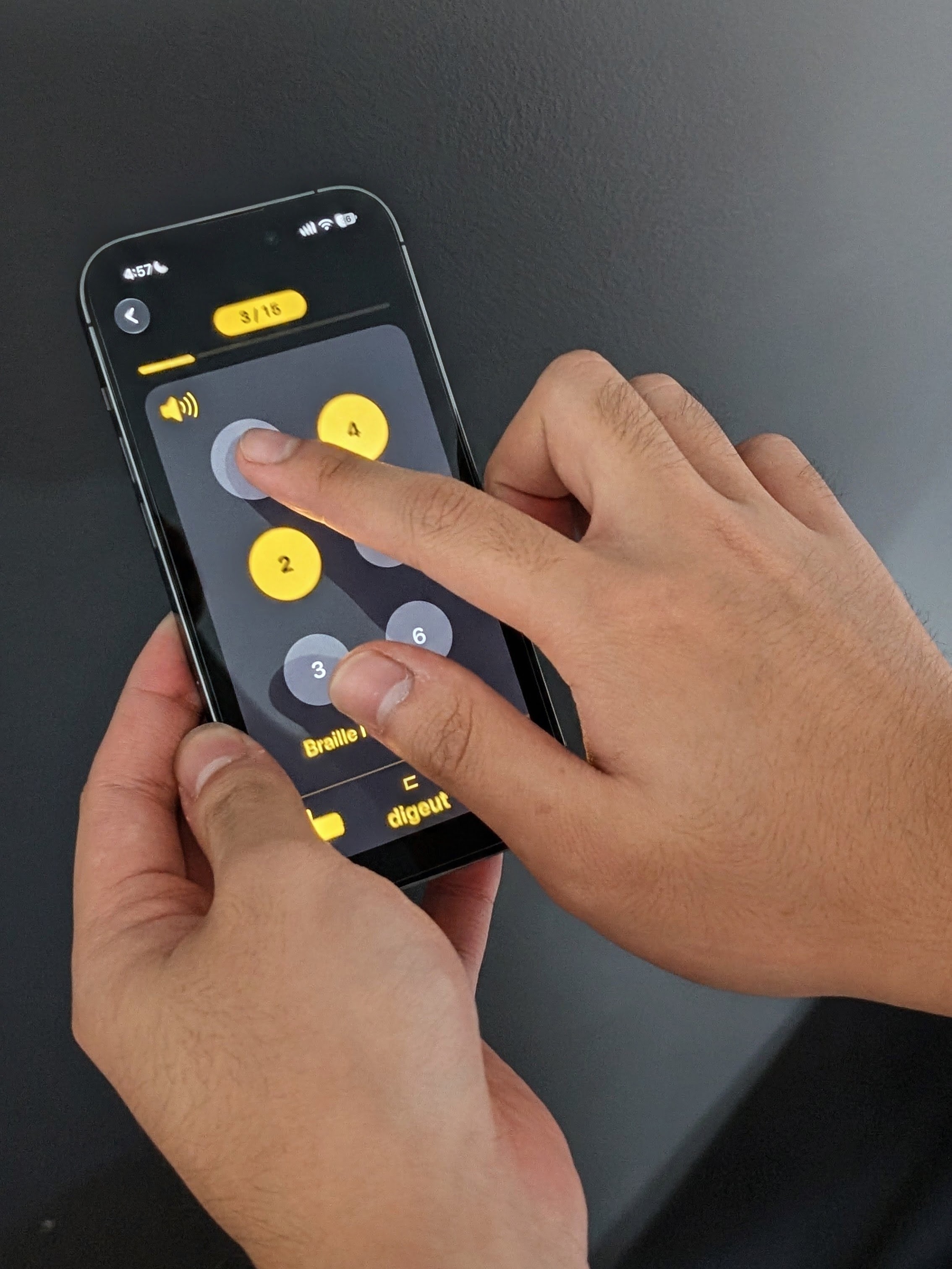 Hands testing the Braille Learning App by touch